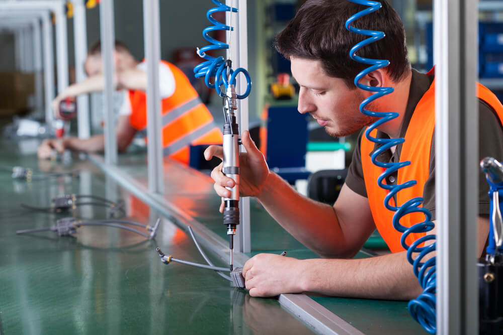 Precision assembly line work with pneumatic tools.