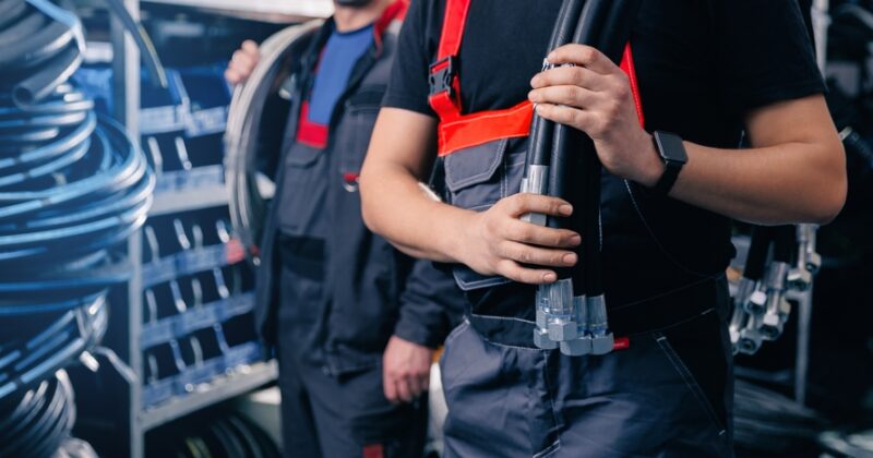 two male workers with hydraulic vs pneumatic systems