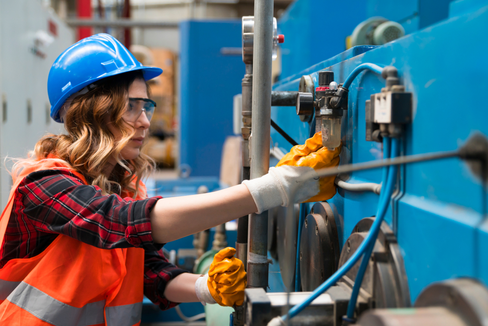 female worker with hydraulic or pneumatic industrial system
