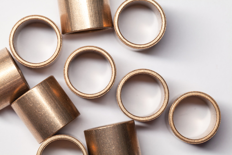 Bronze sleeve bearings on white background