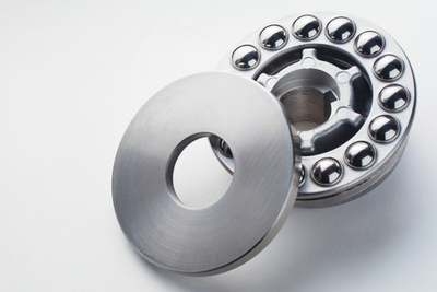 Stainless steel thrust ball bearing. Set of thrust ball bearing and shiny silver ball bearing. Spare parts for roller machine in heavy machinery and automotive or high-pressure washing industry.