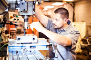 Magnum Industrial Technician works on power transmission components with safety gear.